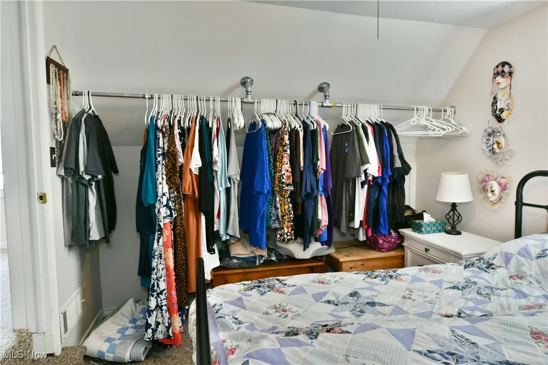 Bedroom featuring lofted ceiling