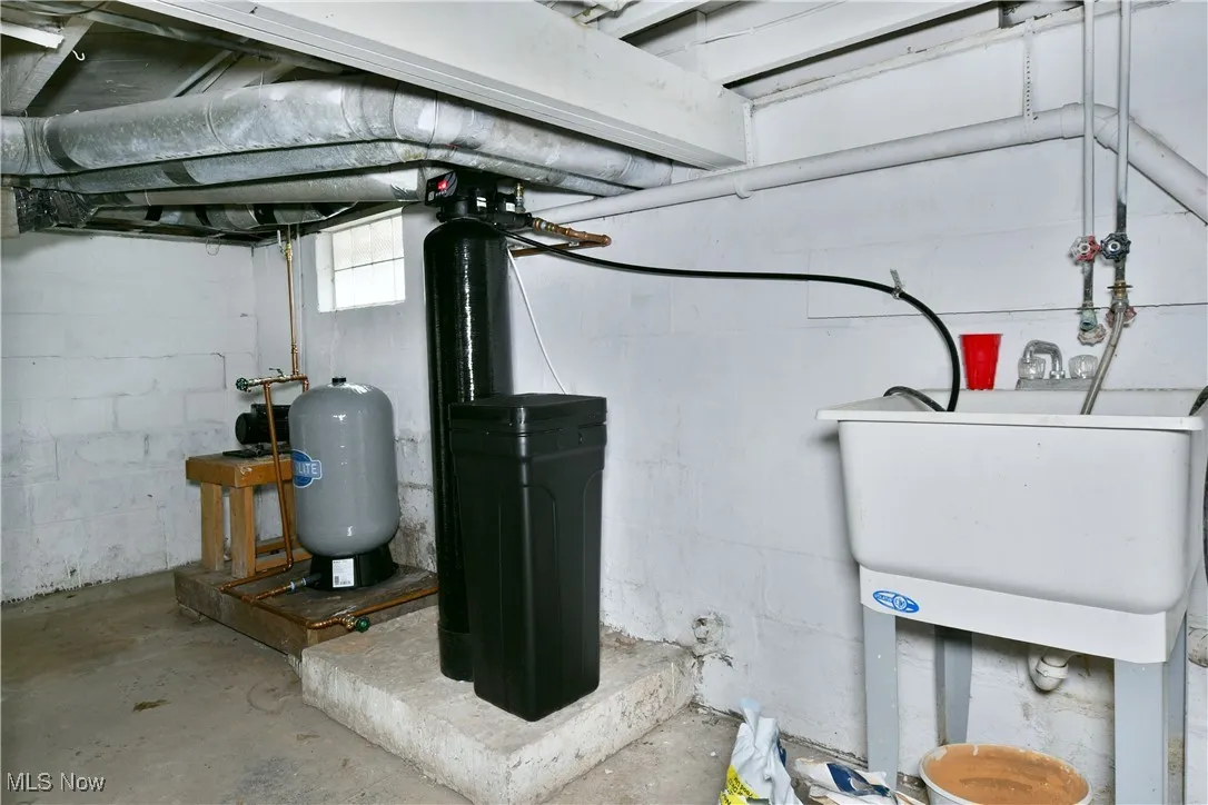 Utility room featuring a sink, and water softener