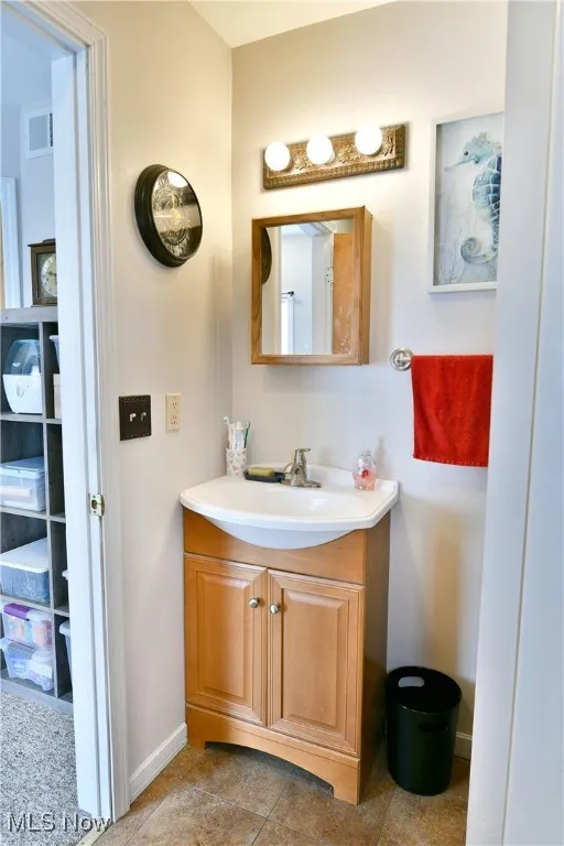 Bathroom featuring vanity and tile patterned flooring