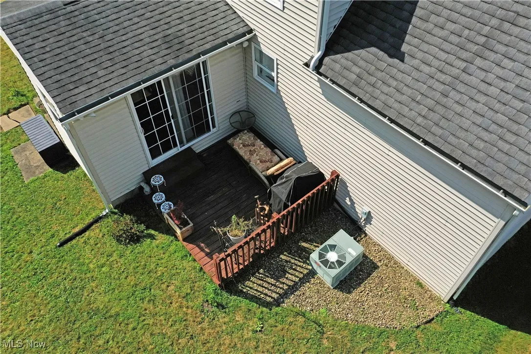View of property exterior with a shingled roof and a cooling unit