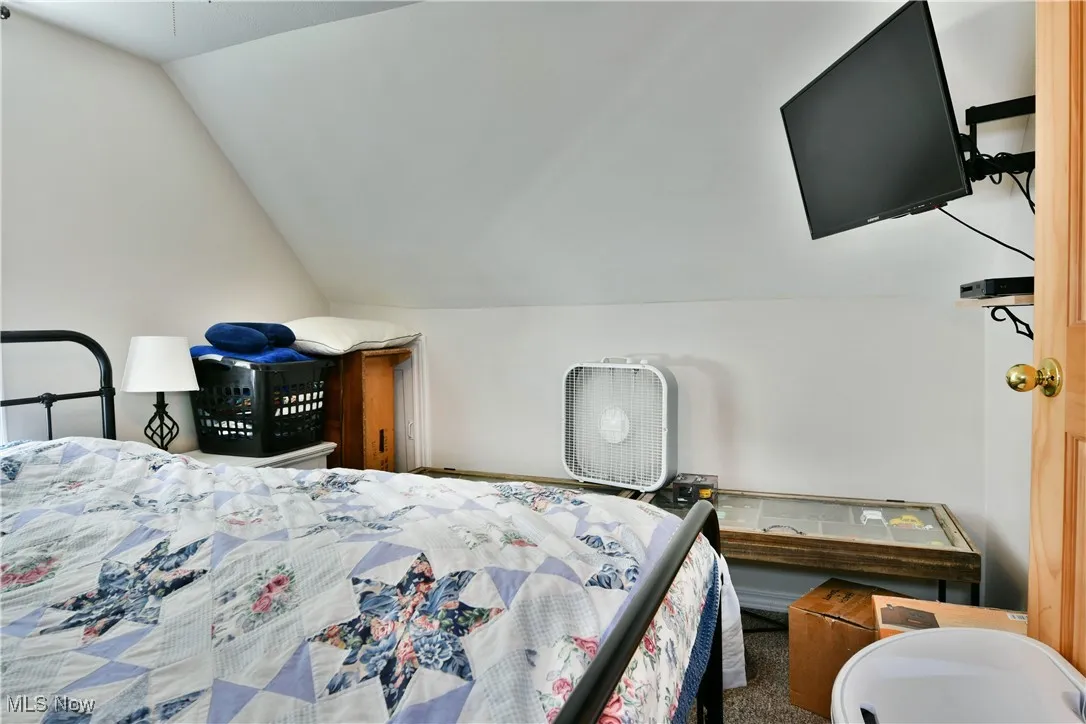 Bedroom featuring vaulted ceiling