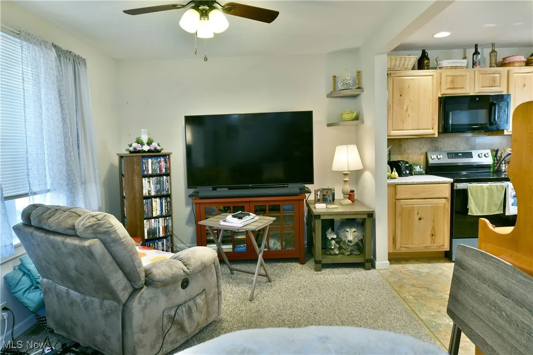 Living room with ceiling fan and baseboards