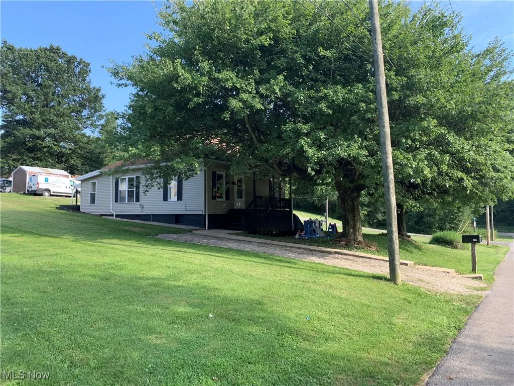 View of green lawn with a porch