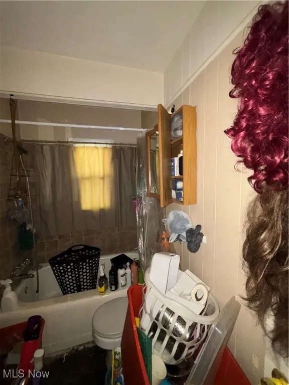 Bathroom featuring shower / tub combo with curtain