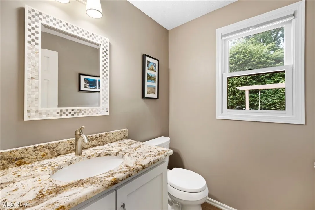 Half bathroom with toilet and vanity