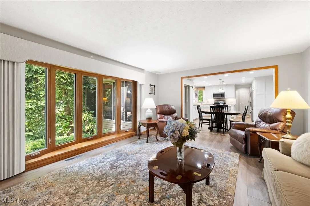 Living area featuring light wood-style floors and recessed lighting