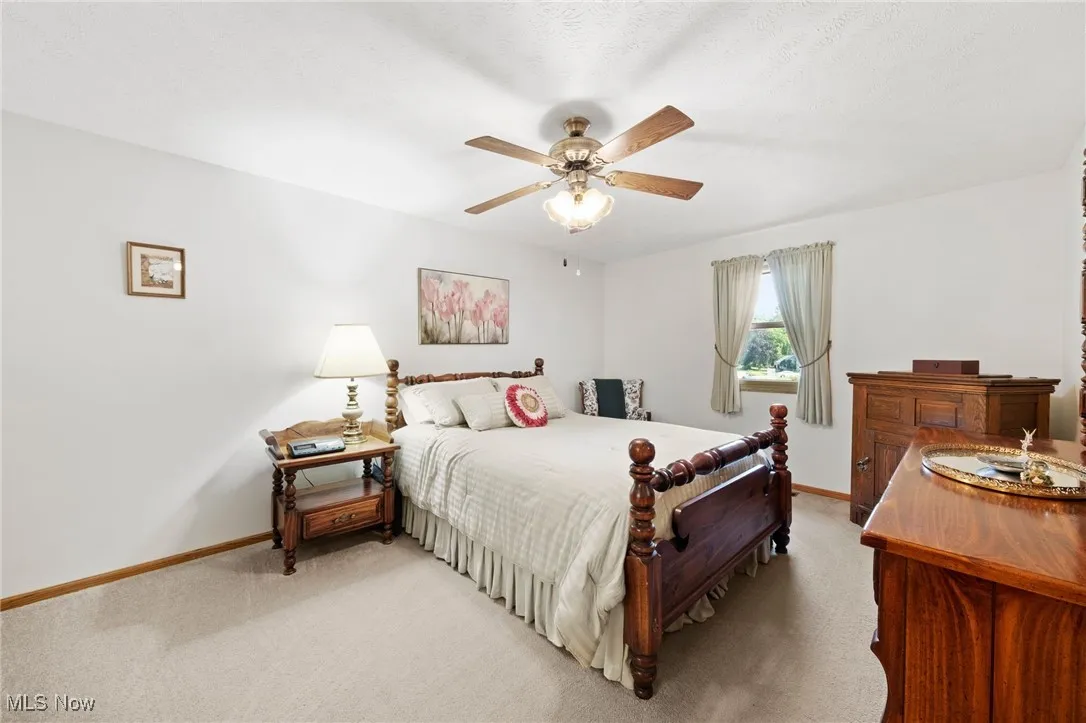 Bedroom featuring light carpet and ceiling fan