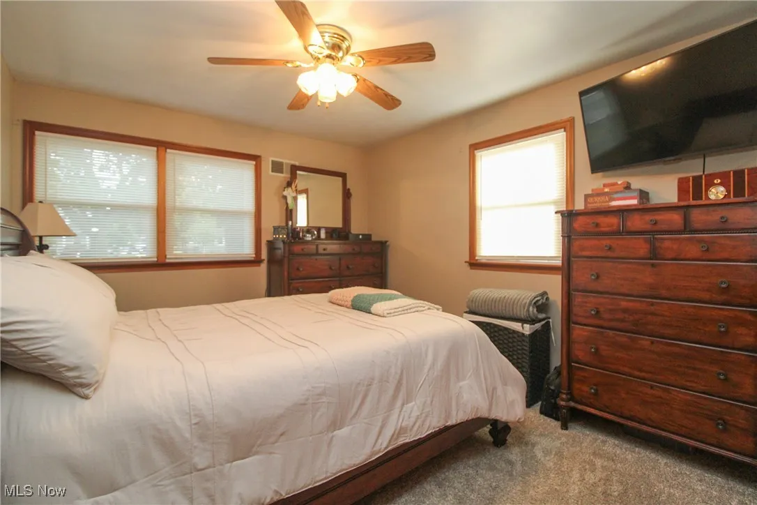 Bedroom with carpet flooring and ceiling fan