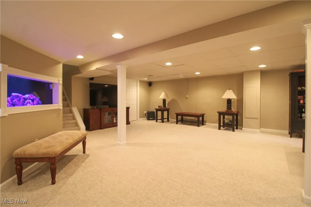 Sitting room featuring recessed lighting, stairway, and light carpet