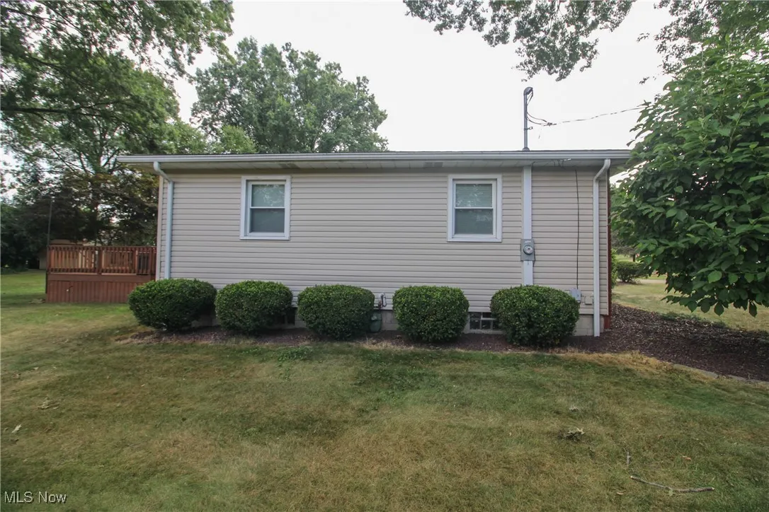 View of side of home featuring a yard