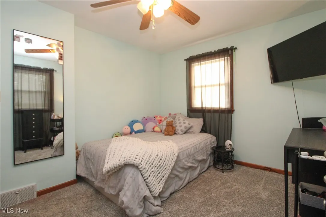 Bedroom featuring carpet flooring and ceiling fan