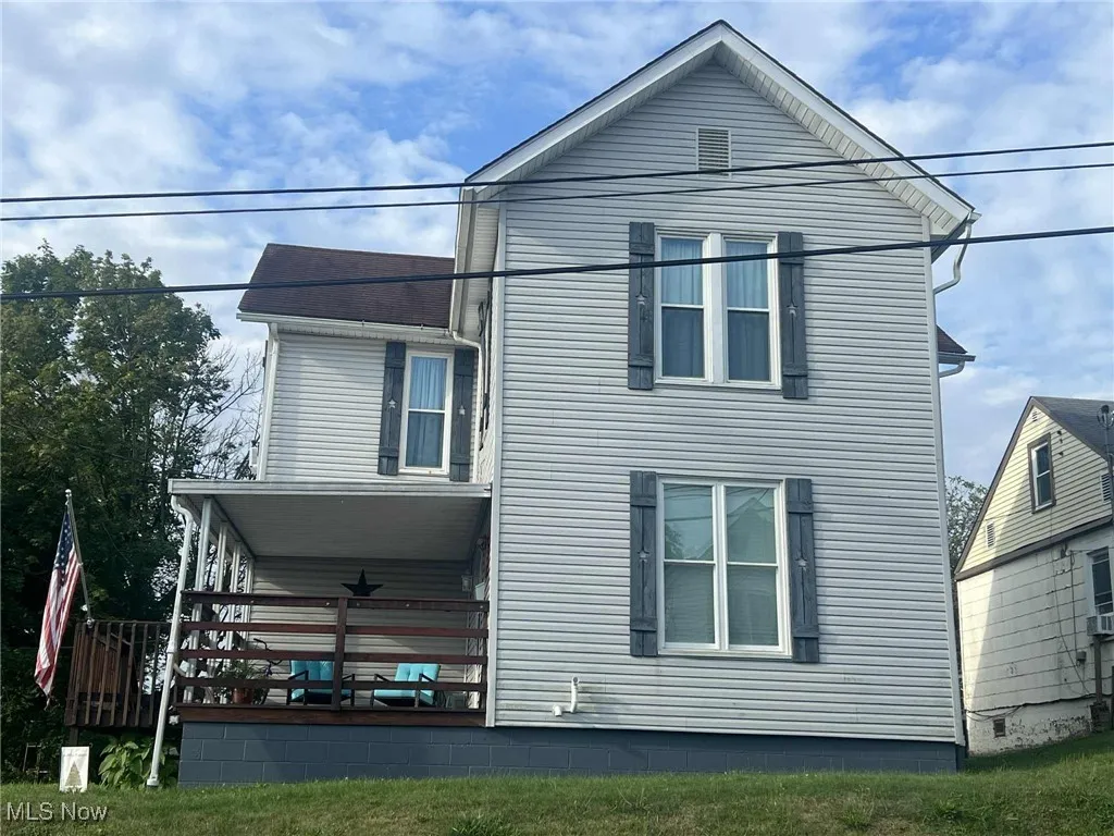 View of property exterior featuring a deck