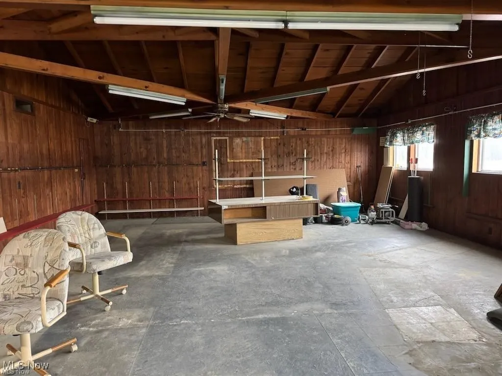 Garage with wooden walls and wooden ceiling