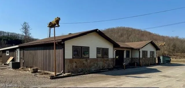 View of front of property featuring stone siding and a mountain view