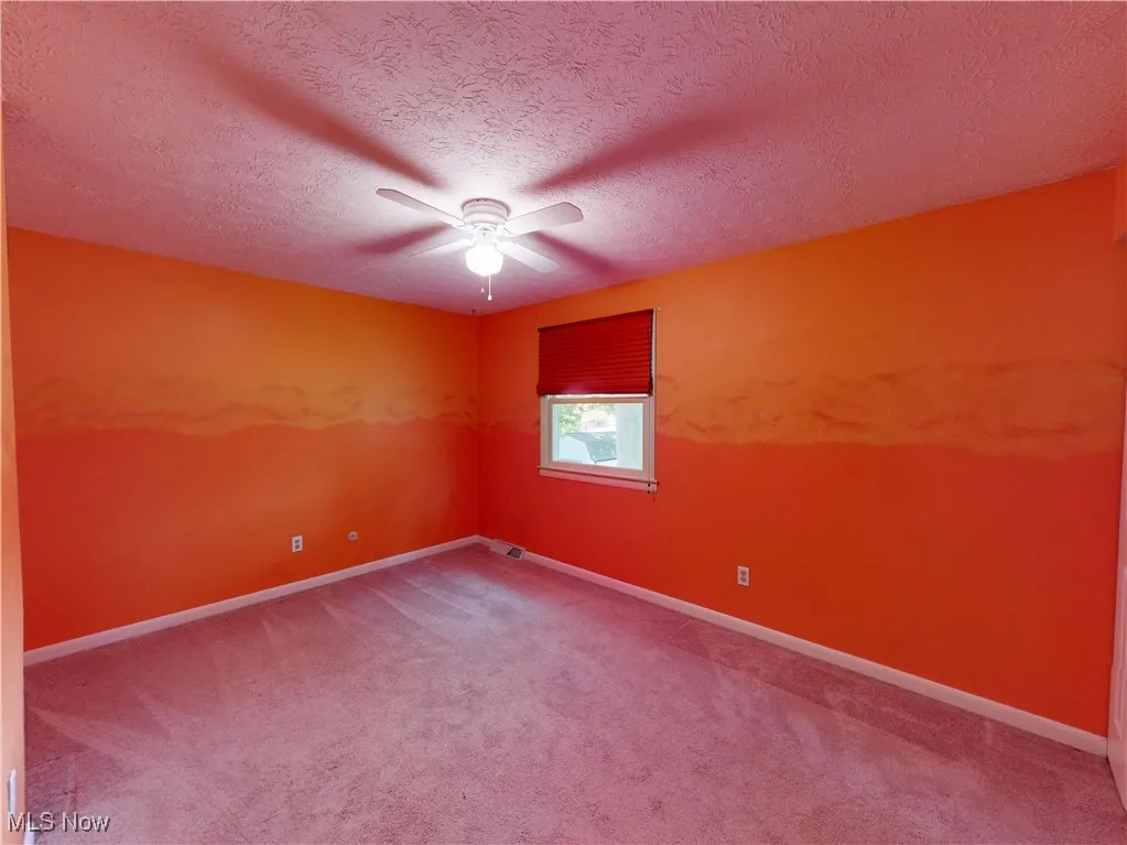 2nd bedroom with carpet floors, a textured ceiling, and ceiling fan