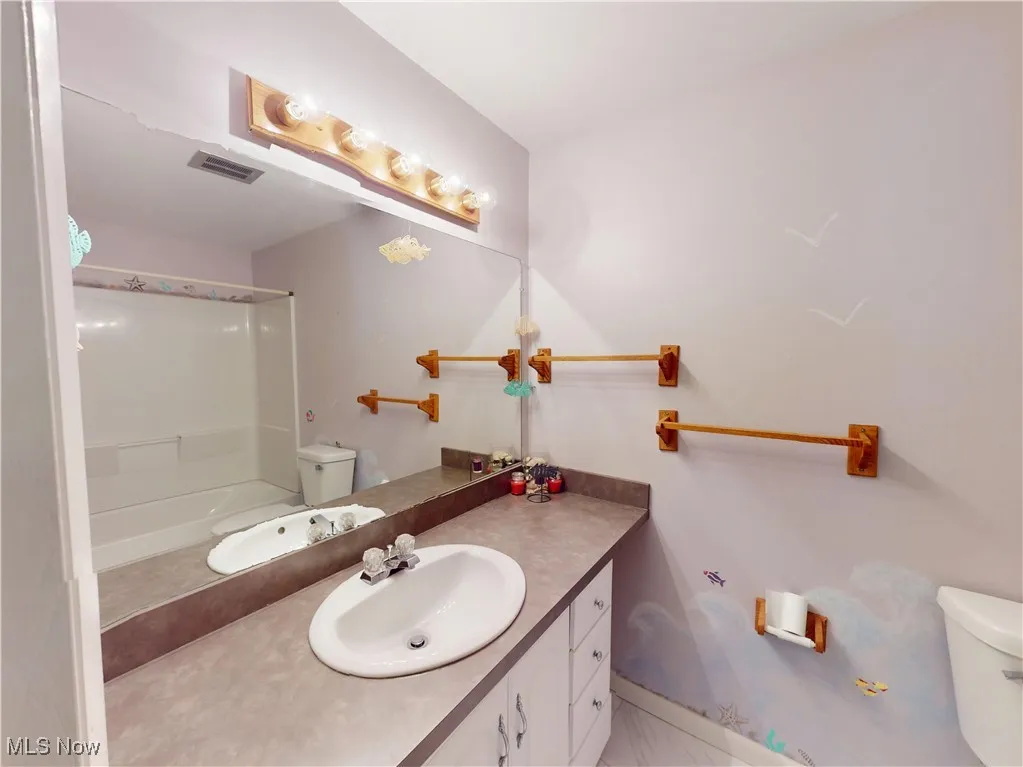 Bathroom featuring vanity and tub / shower combination