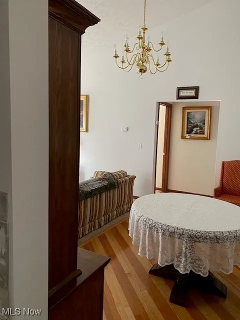 Bedroom featuring light wood-type flooring and a chandelier