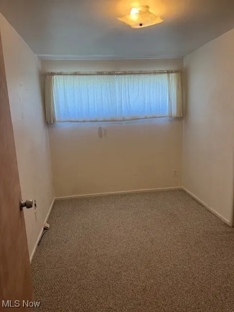 Empty room with carpet floors