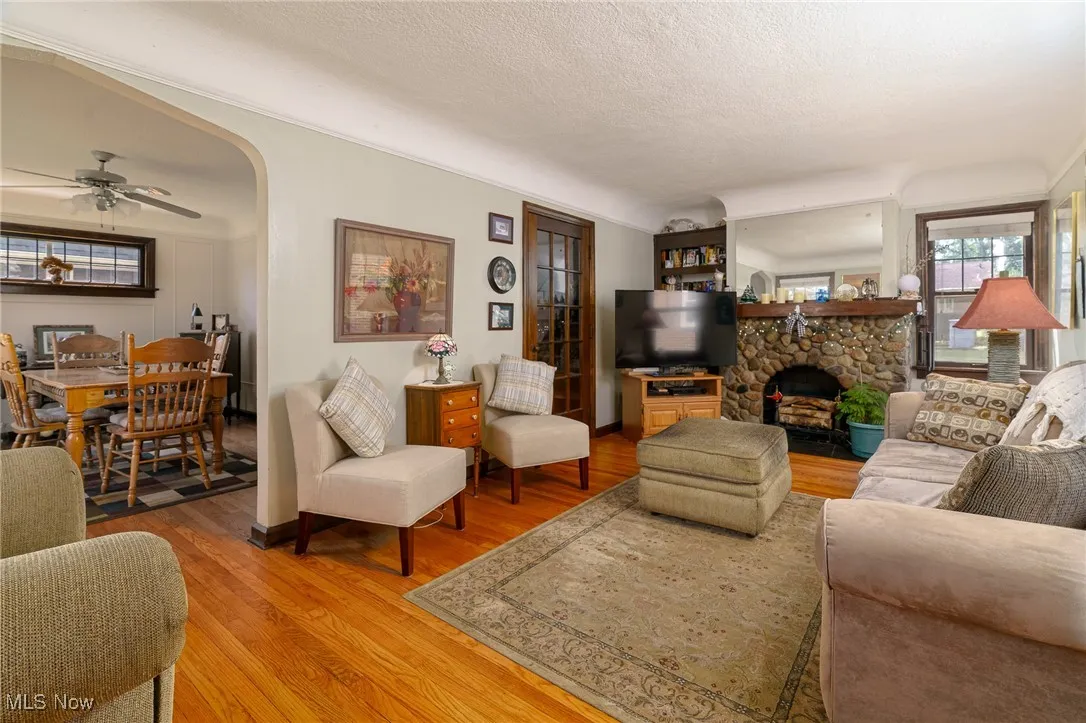 Spacious living room complimented with decorative stone fireplace and built in bokcase