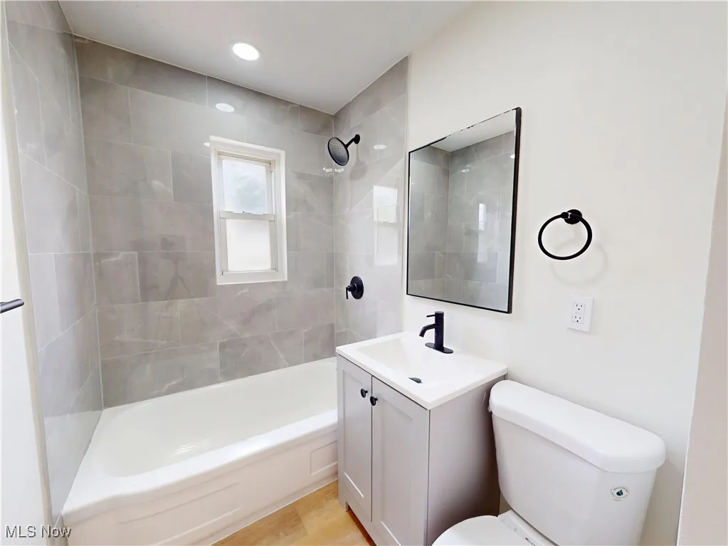 Full bathroom with vanity and washtub / shower combination