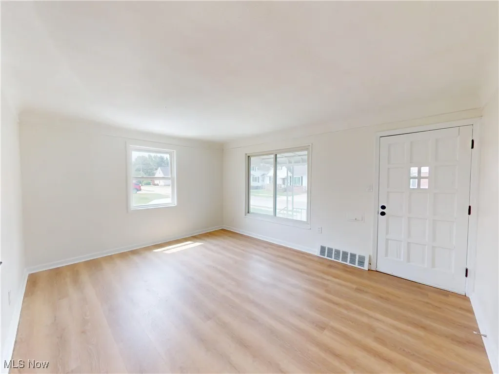 Foyer featuring light wood-style floors and baseboards