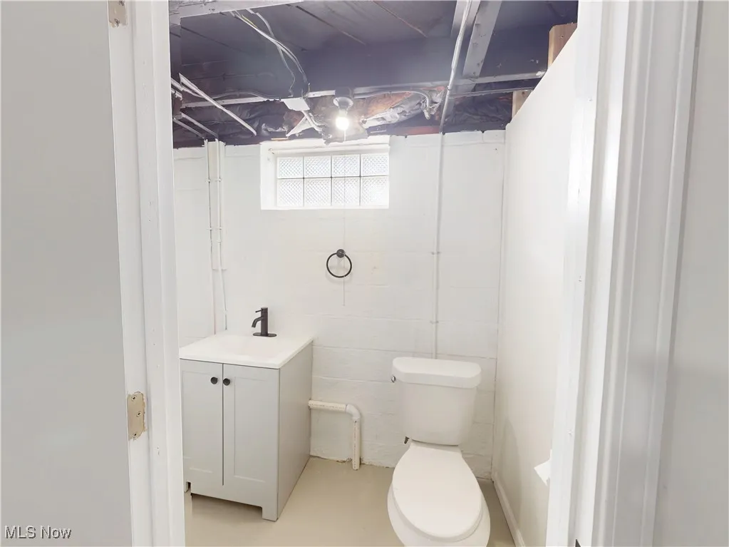 Bathroom featuring vanity and concrete floors