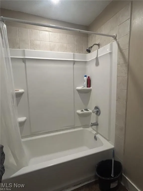 Full bath featuring shower / tub combo with curtain