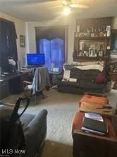 Living area with ceiling fan and an office area