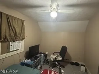 Office featuring lofted ceiling, a textured ceiling, ceiling fan, and cooling unit