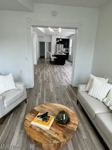 Living room with light wood-type flooring and baseboards