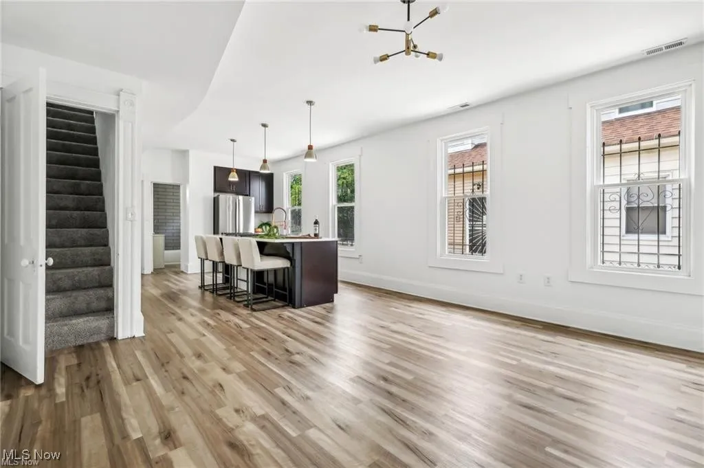 Living room with stairs and light wood finished floors