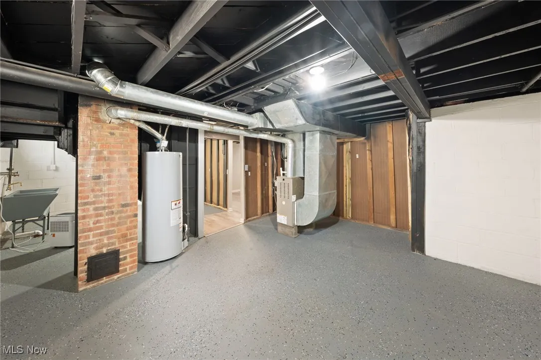 Unfinished basement with water heater and heating unit