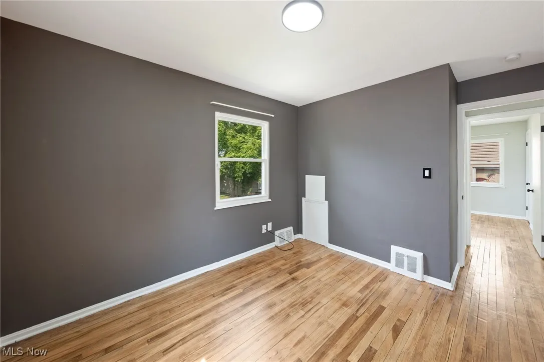 Bedroom featuring light wood finished floors and baseboards