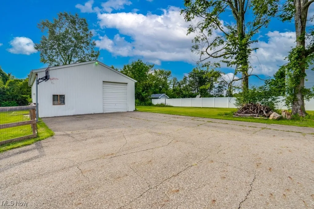 Detached garage with asphalt driveway
