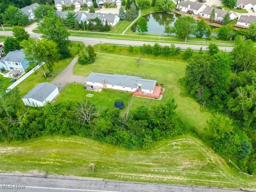 Aerial view of residential area featuring a nearby body of water