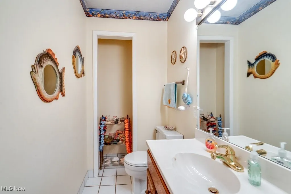 Bathroom with tile patterned floors and vanity
