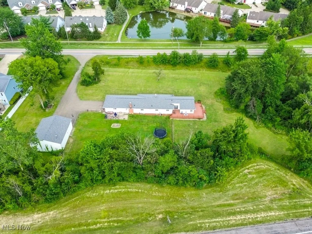 Aerial perspective of suburban area featuring a large body of water