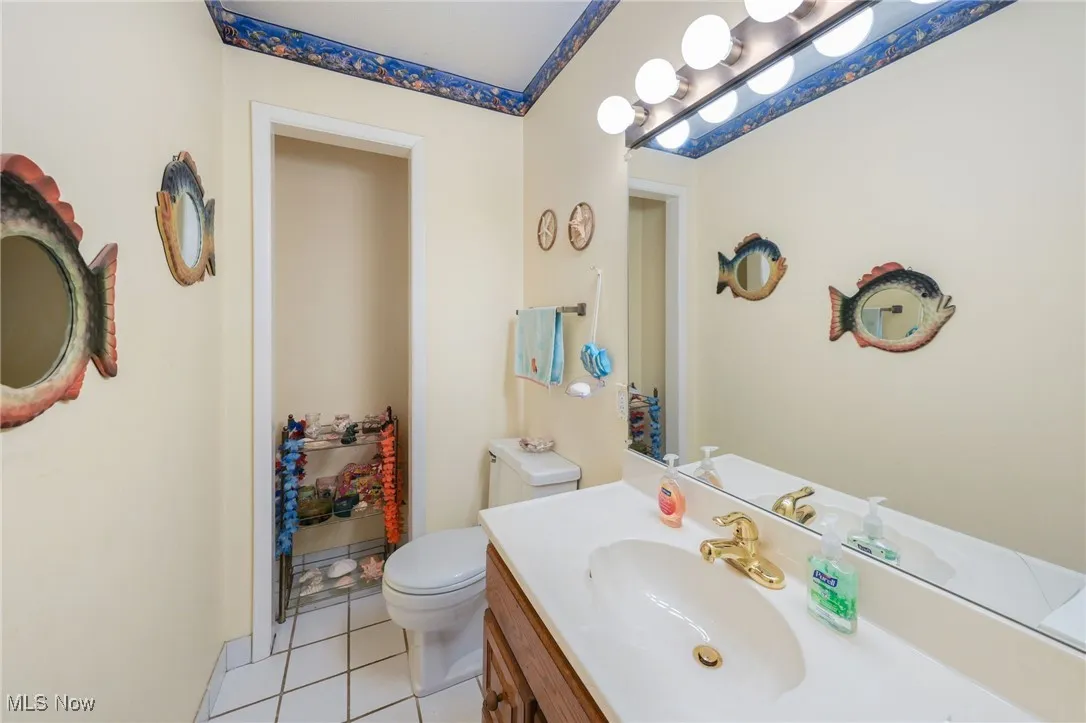 Bathroom featuring light tile patterned floors and vanity