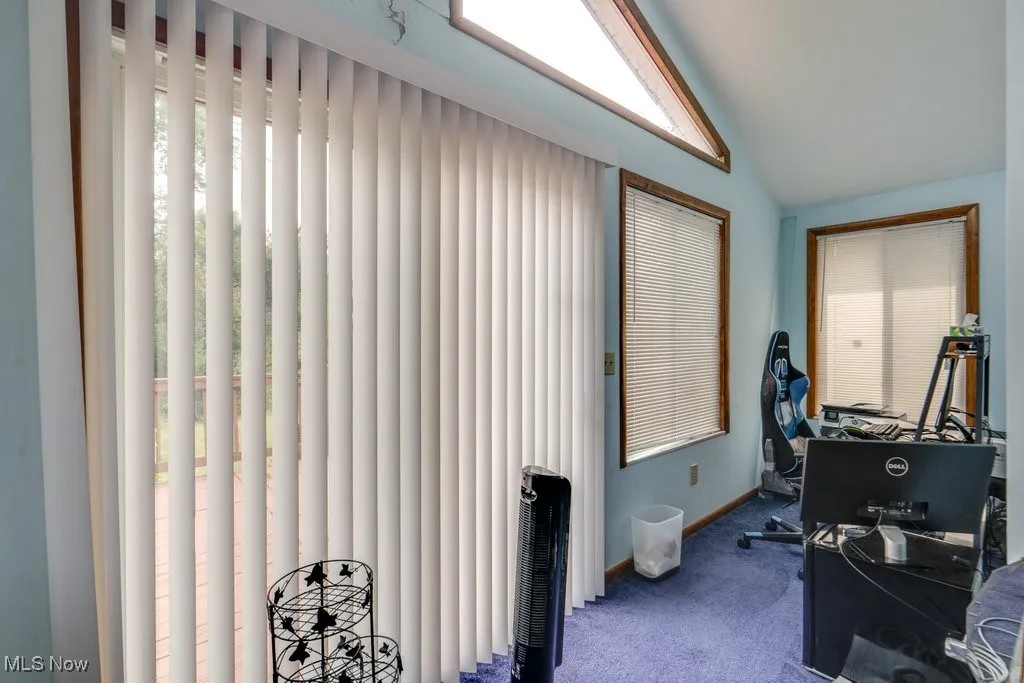 Home office with carpet flooring and lofted ceiling