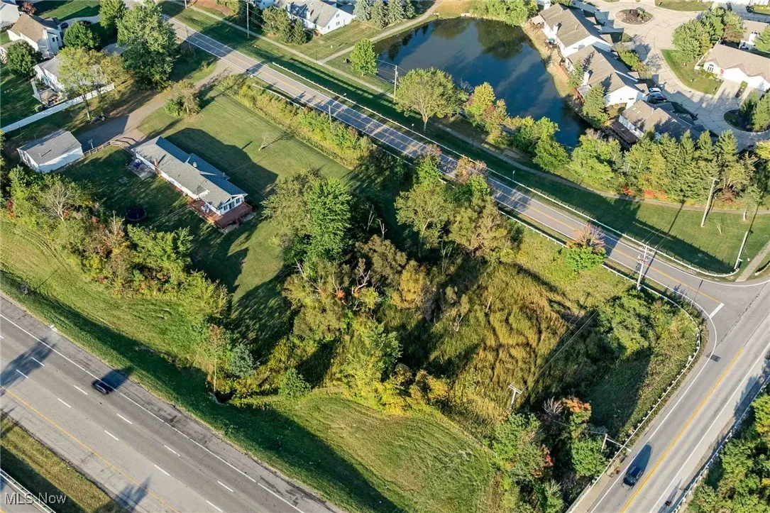 Aerial view of property and surrounding area featuring a large body of water