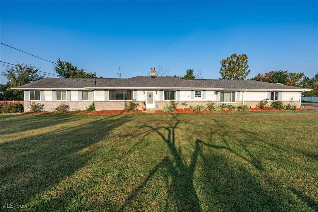 Single story home with a front yard and a chimney