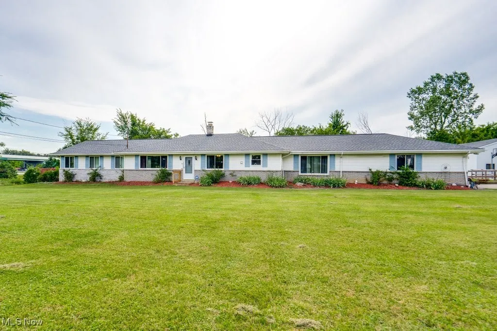 Ranch-style home with brick siding and a front lawn