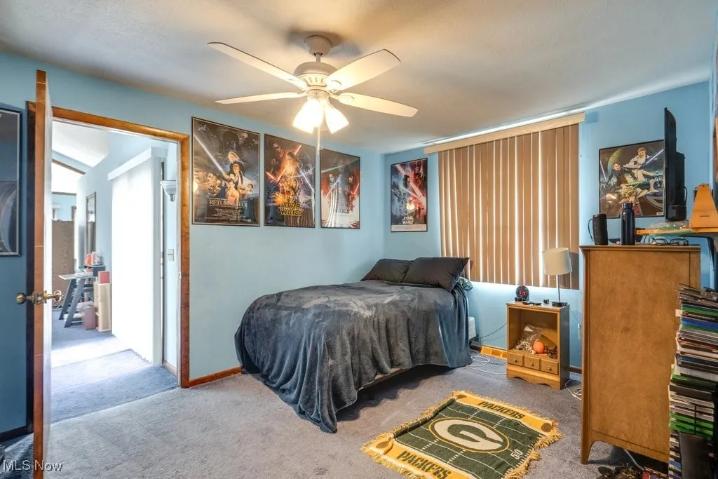 Bedroom with carpet floors and a ceiling fan