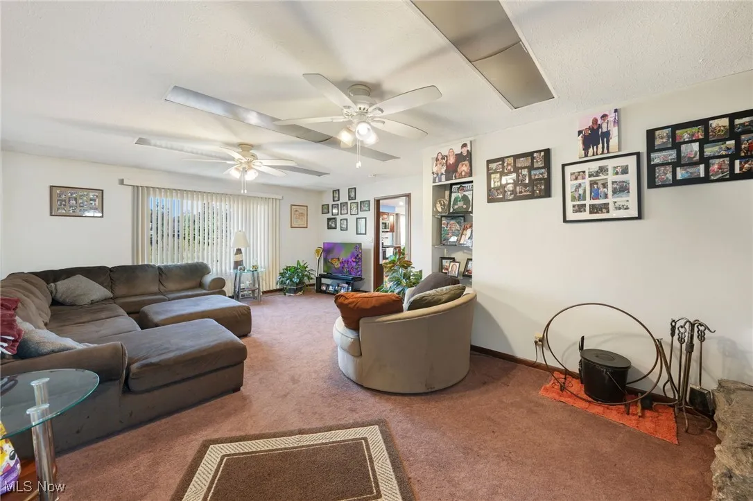 Carpeted living area with baseboards
