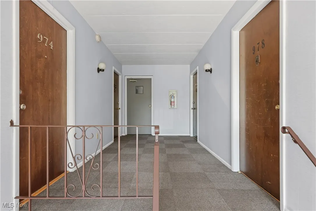 Hallway featuring an upstairs landing and carpet flooring