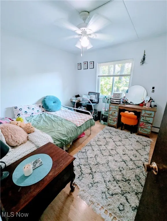 Bedroom featuring light wood-style floors and ceiling fan