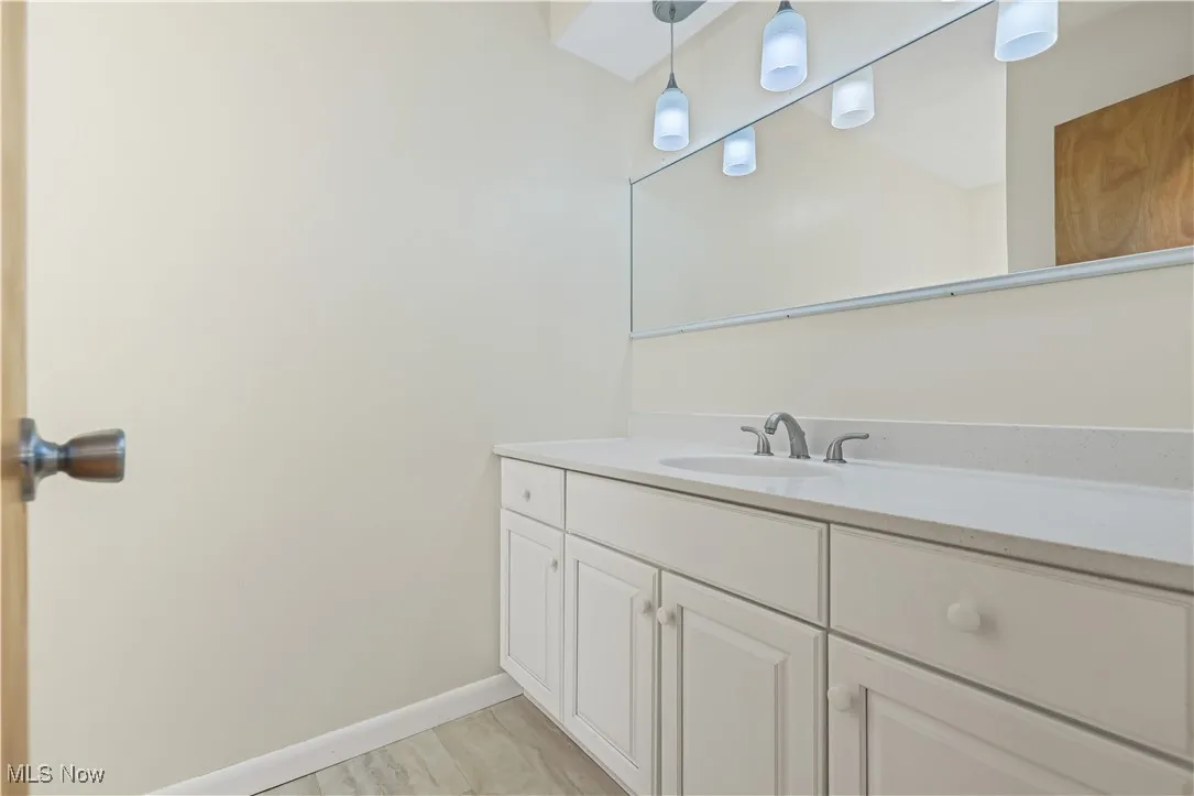 Bathroom with vanity and baseboards