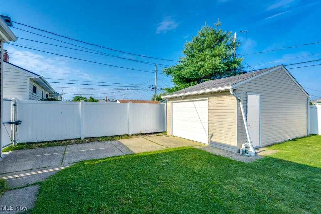 View of yard featuring an outbuilding and a detached garage