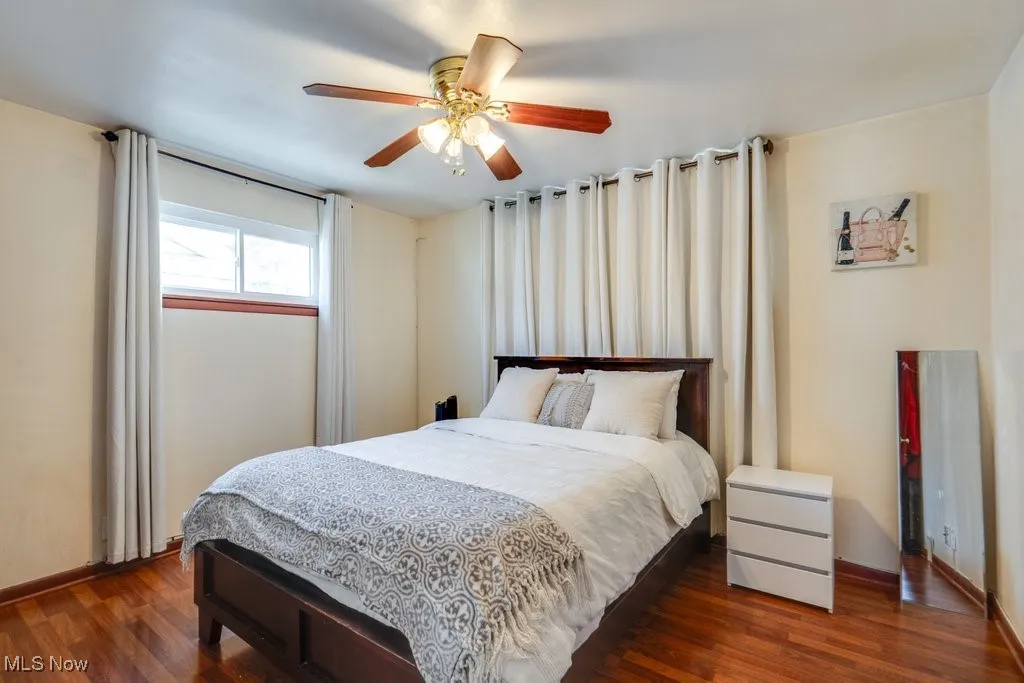Bedroom featuring wood finished floors and a ceiling fan