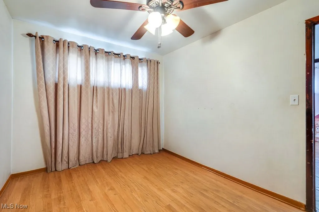 Spare room with light wood-style flooring and a ceiling fan